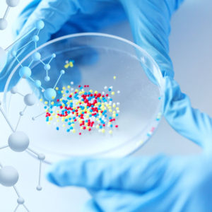 36669842_s 36669842 - science, chemistry, biology, medicine and people concept - close up of scientist or doctor hands holding petri dish with chemical capsules chemical in laboratory