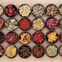 24961478-Large-chinese-herbal-medicine-selection-in-wooden-bowls-over--Stock-Photo 24961478 - large chinese herbal medicine selection in wooden bowls over papyrus background